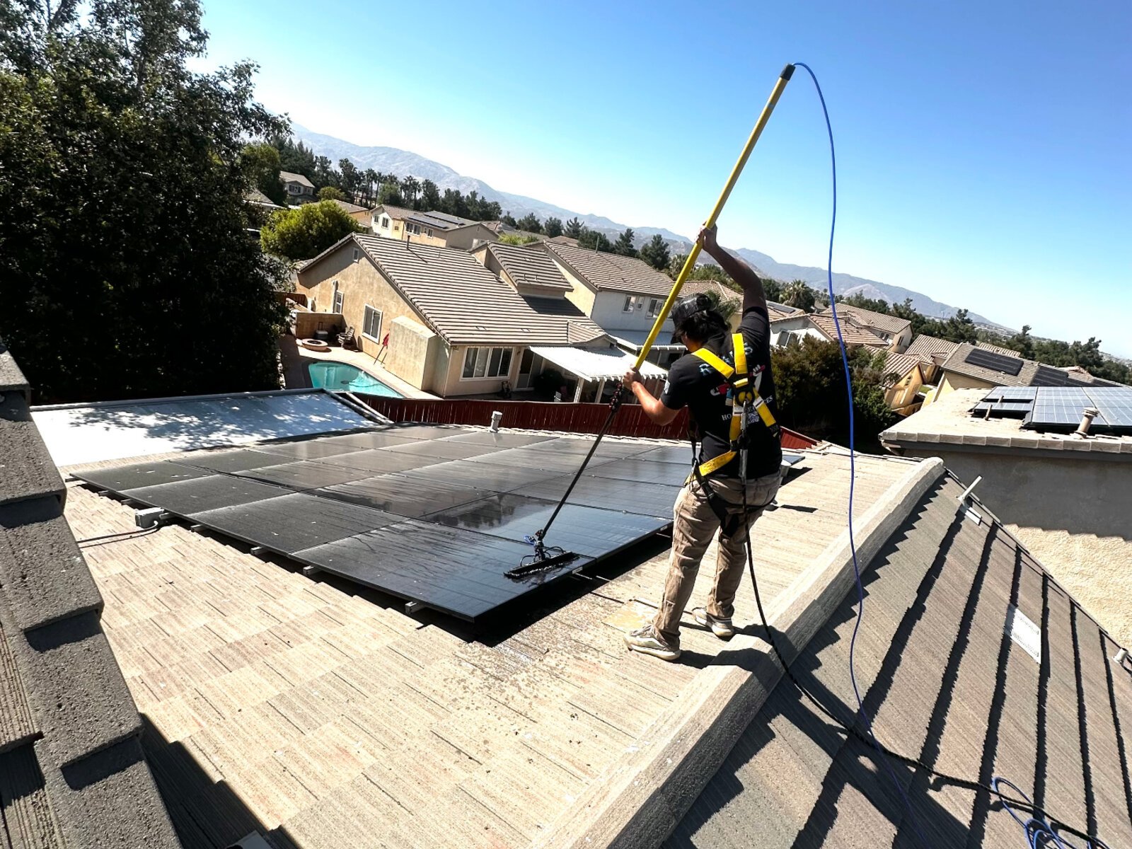 Solar panel cleaning service on tile roof home in Riverside County