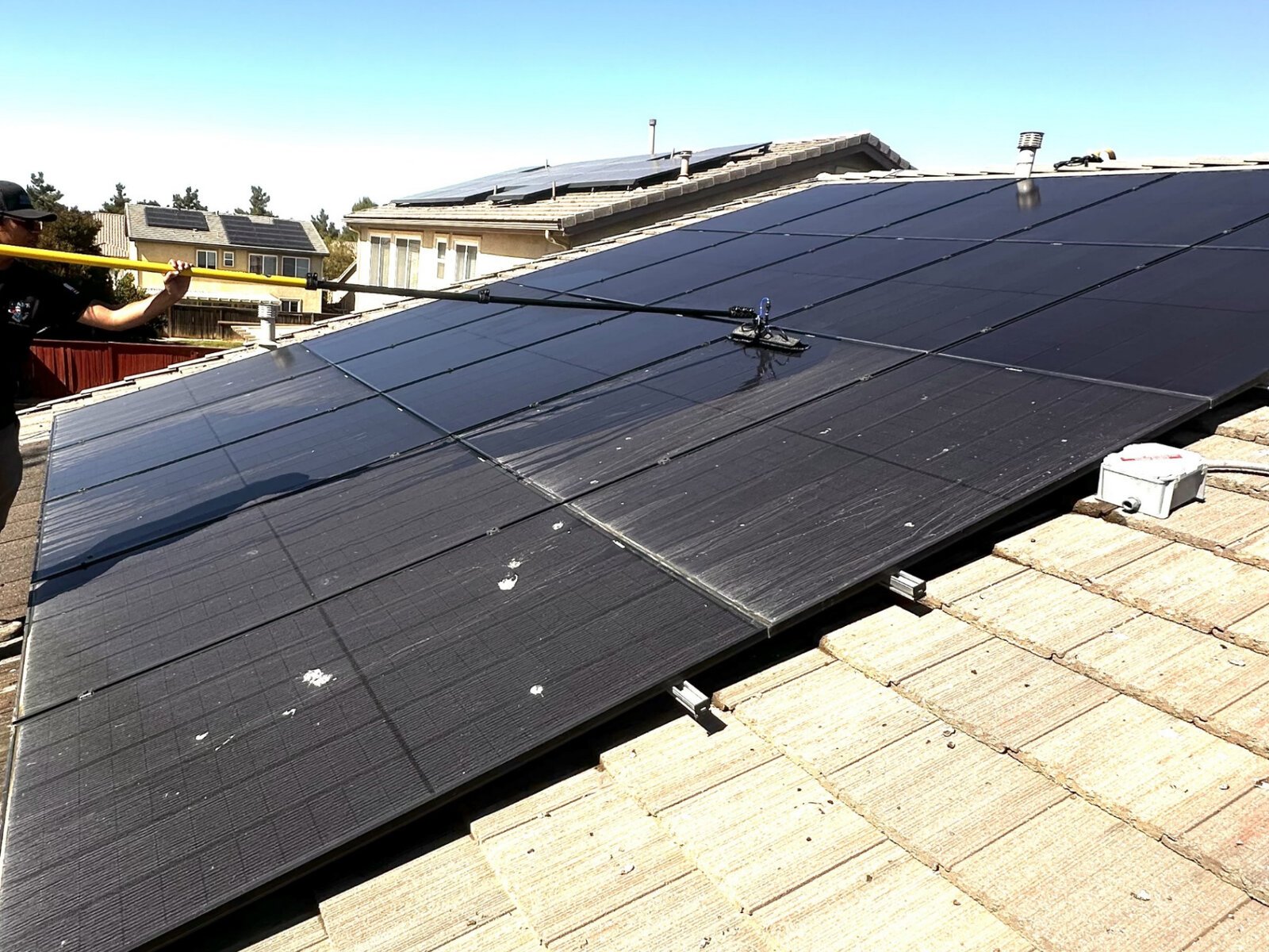 Close-up of solar panels being cleaned to remove bird droppings and dust